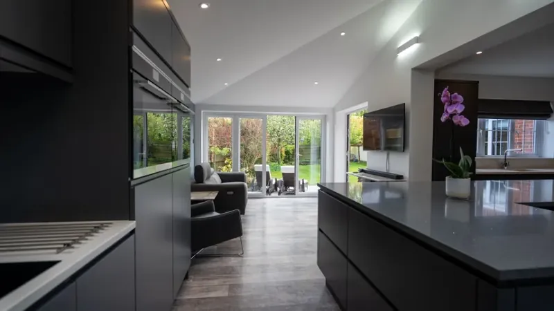 Ultra modern white kitchen with clean lines inside a rear extension in Whatfield, Suffolk