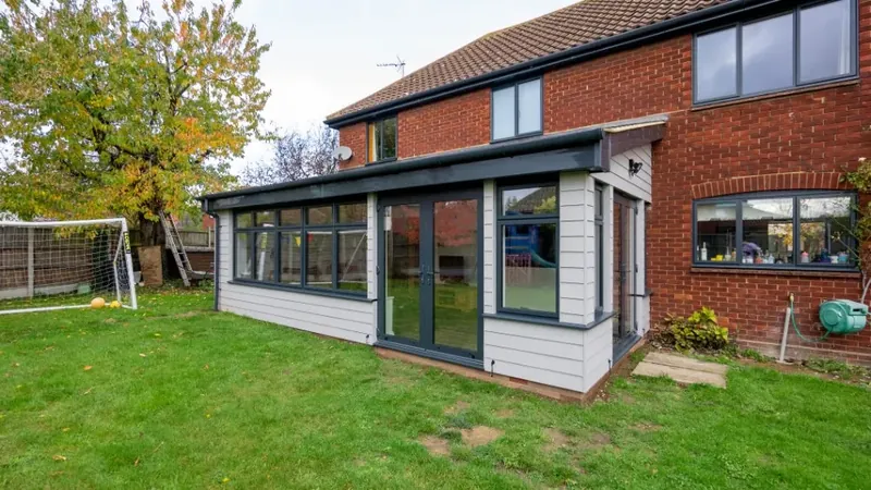 Rear view of a completed single storey extension in Elmsett, Suffolk, with a lawn in the foreground