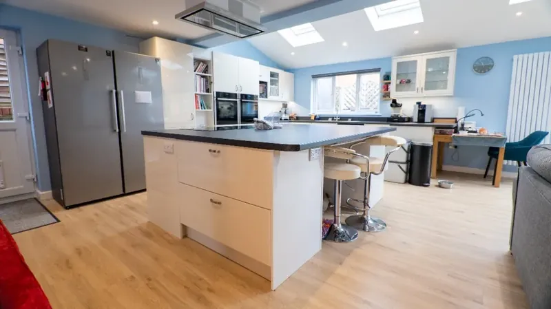 Open plan kitchen, living and dining space with roof lights inside a wraparound extension in Hadleigh, Suffolk
